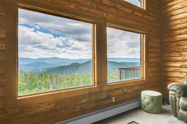 a view of a room that has a bed and a view of balcony