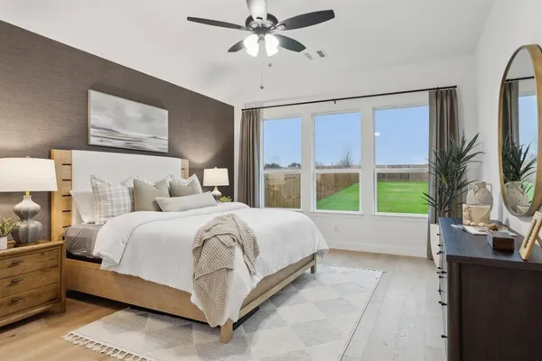 a bedroom with a large bed and a large window
