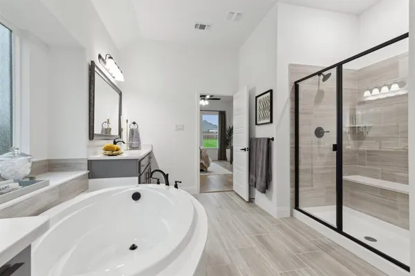 a bathroom with a tub sink and mirror