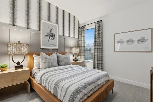 a bedroom with a large bed and a window
