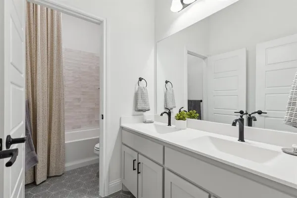 a bathroom with a double vanity sink and a mirror