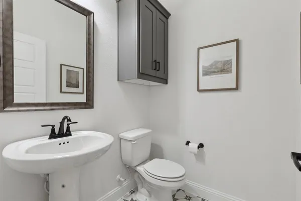a view of a dining room with furniture a chandelier and wooden floor