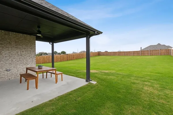 a view of a big house with a big yard and large trees
