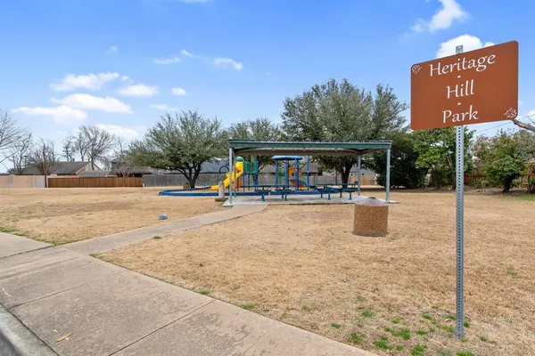 a view of a swimming pool with a lounge chair and dinning table under an umbrella