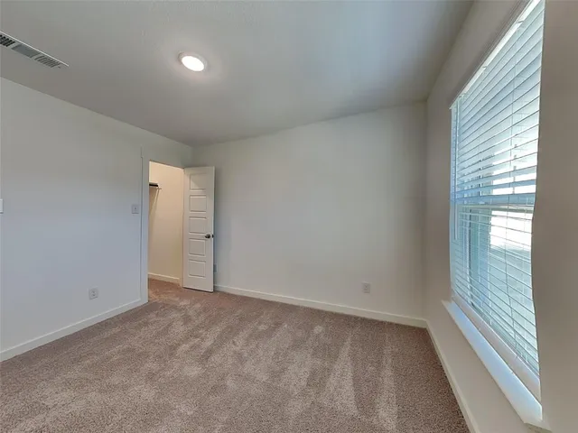 a view of an empty room and a window