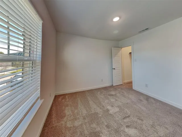 a view of an empty room and a window