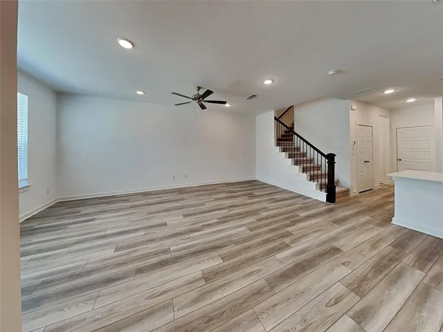 a view of a room with wooden floor and stairs