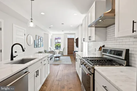 a kitchen with sink stove and refrigerator