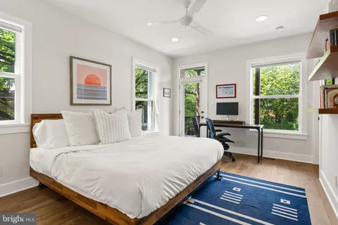 a bedroom with a large bed and a tv