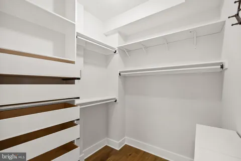 a view of walk in closet with empty racks