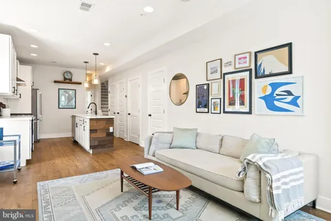 a living room with furniture and kitchen view