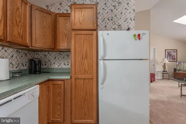 a white refrigerator freezer sitting in a kitchen