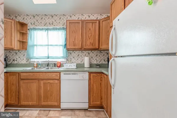 a kitchen with a white cabinets sink and a window