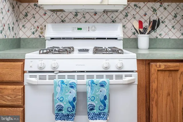 a stove top oven sitting inside of a kitchen