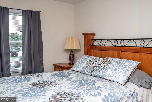 a bedroom with a bed and a lamp on table