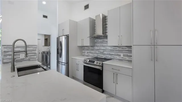 a kitchen with stainless steel appliances granite countertop a stove and a sink