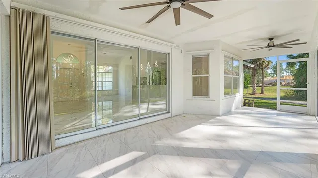 a view of a livingroom with a ceiling fan window and outside view