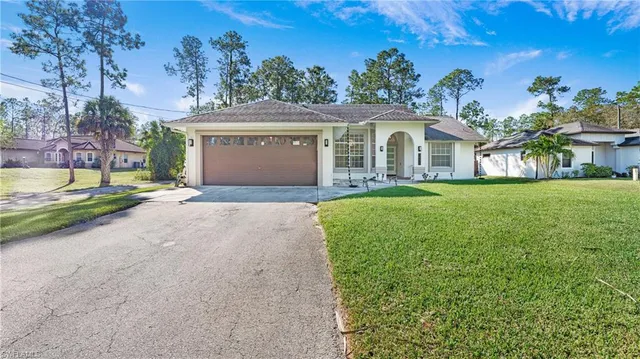 a front view of a house with a yard and garage