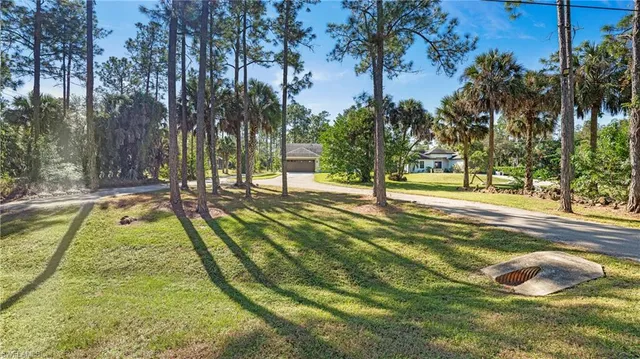 a view of yard with swimming pool and trees