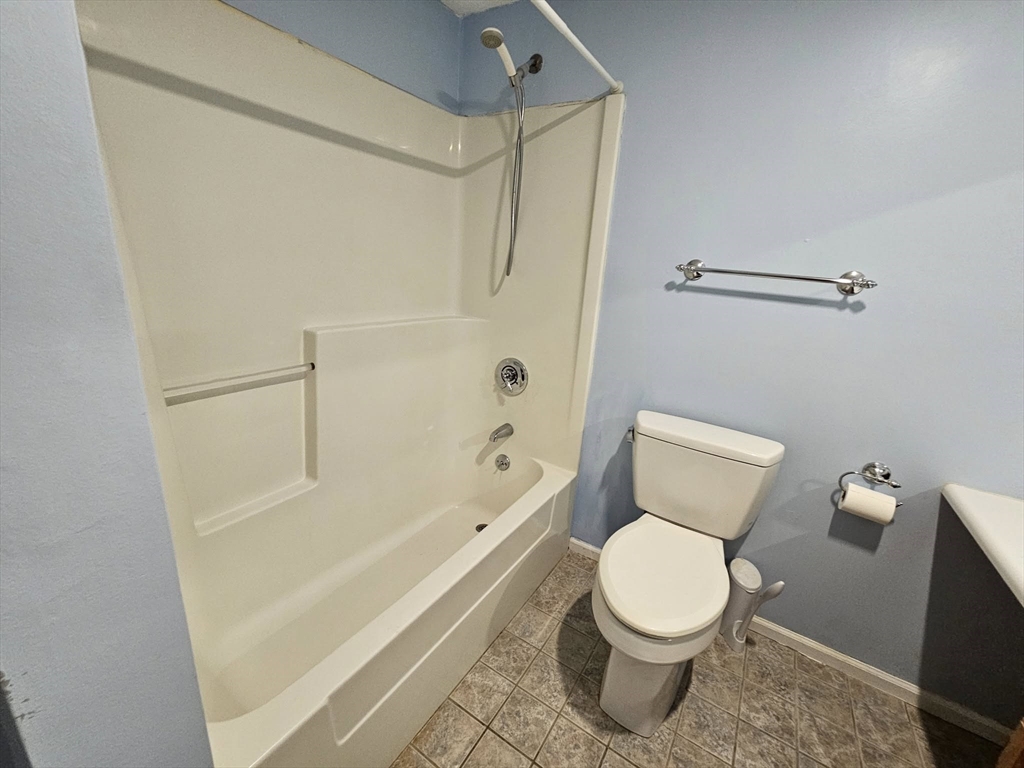 35 Prospect Street, Unit 215 Woburn, MA 01801 - Photo 14 of 37 a white toilet sitting next to a bath tub