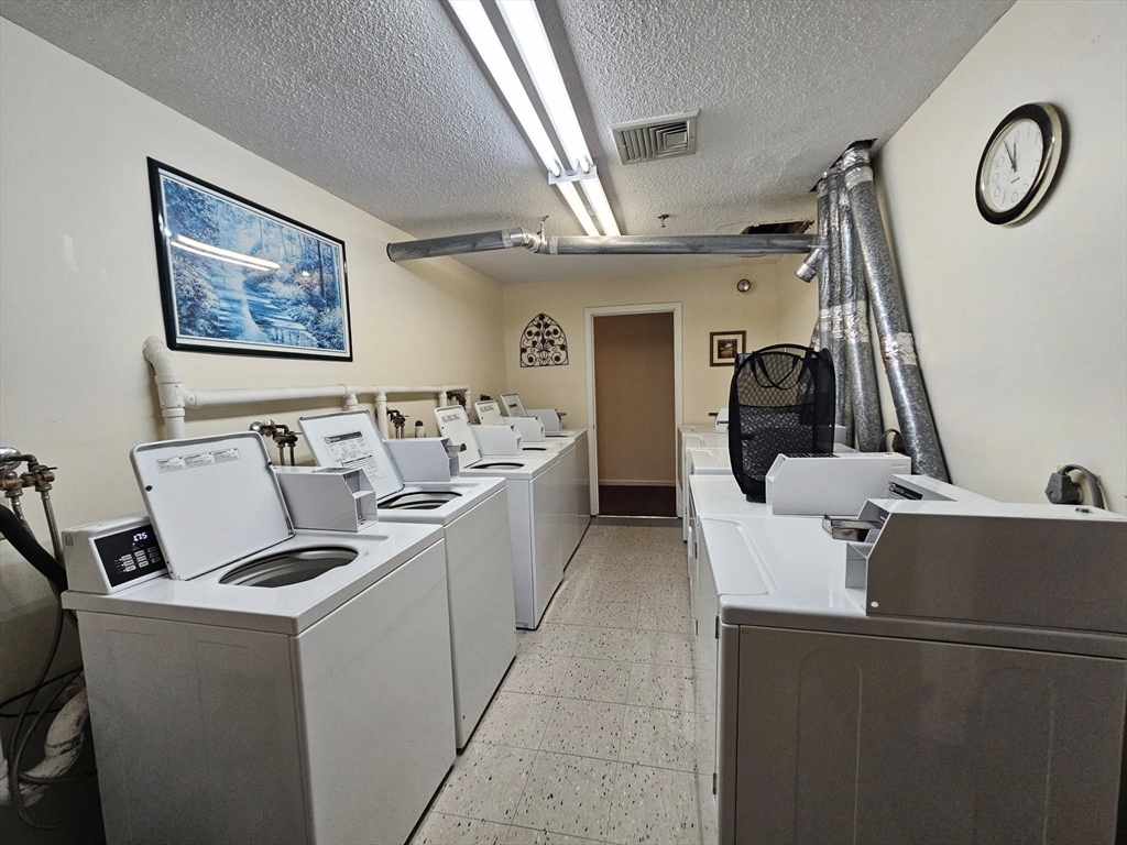 35 Prospect Street, Unit 215 Woburn, MA 01801 - Photo 19 of 37 a living room with furniture a window and a table