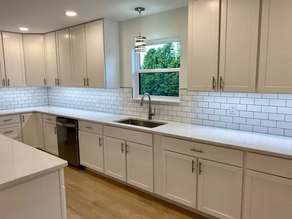 a kitchen with a sink cabinets and window