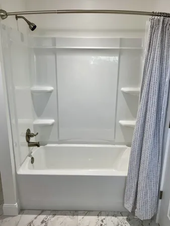 a bathroom with a bathtub and a shower