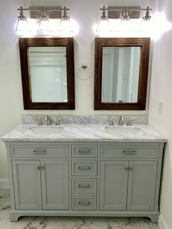 a bathroom with a granite countertop sink vanity and mirror