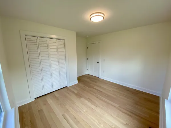 an empty room with wooden floor