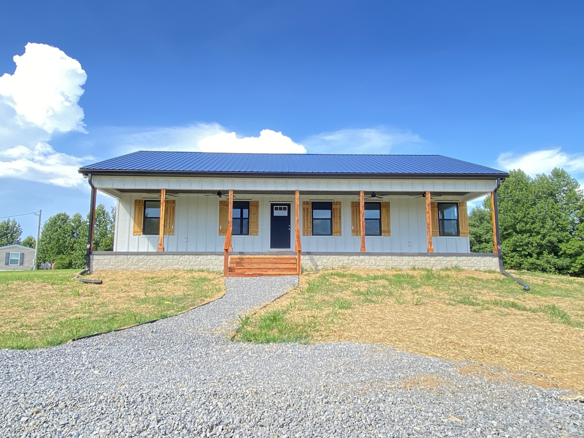 25 Ferguson Hollow Road Chestnut Mound, TN 38552 - Photo 3 of 49 a front view of a house with a garden and yard