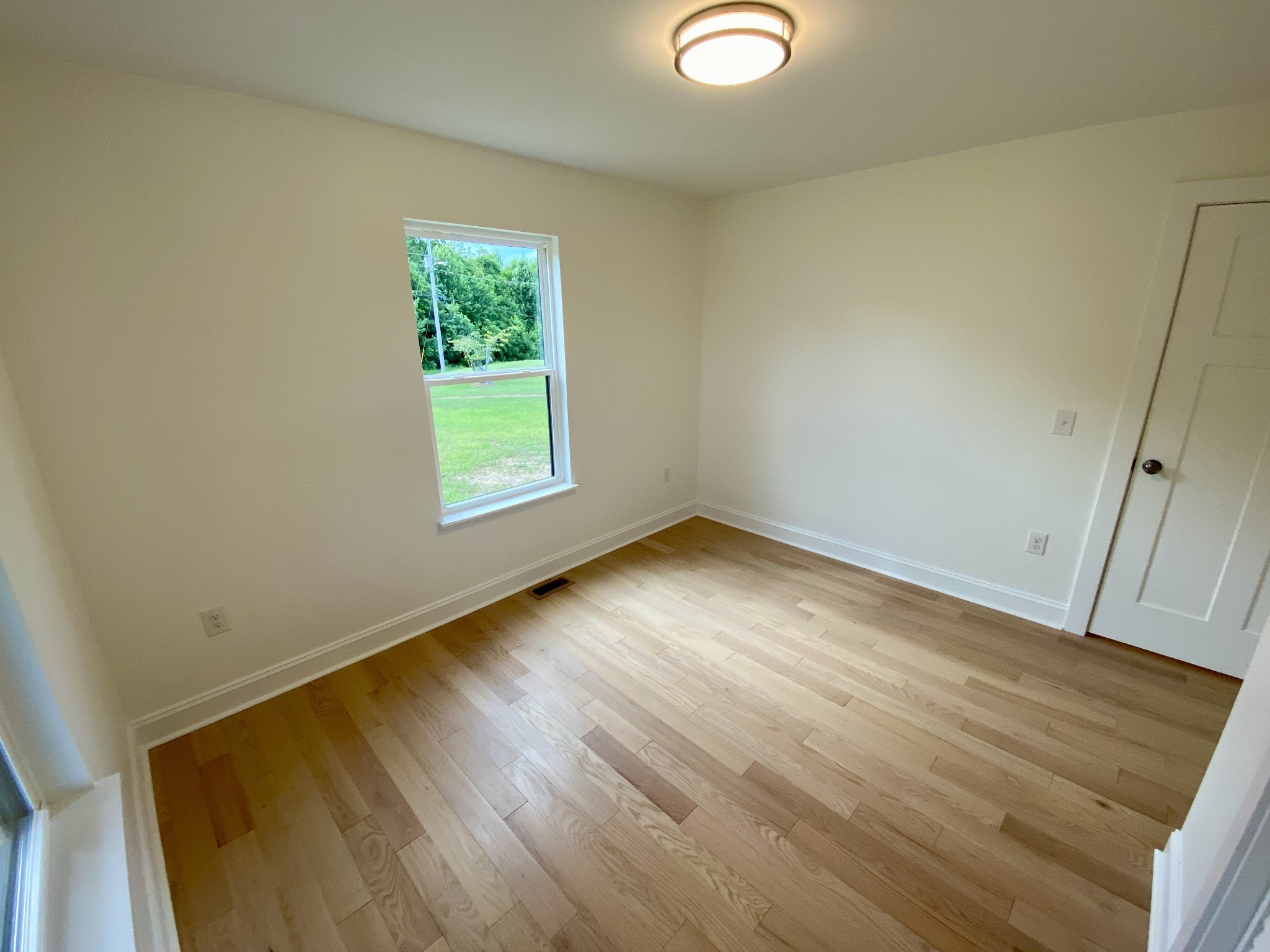 25 Ferguson Hollow Road Chestnut Mound, TN 38552 - Photo 32 of 49 an empty room with wooden floor and windows