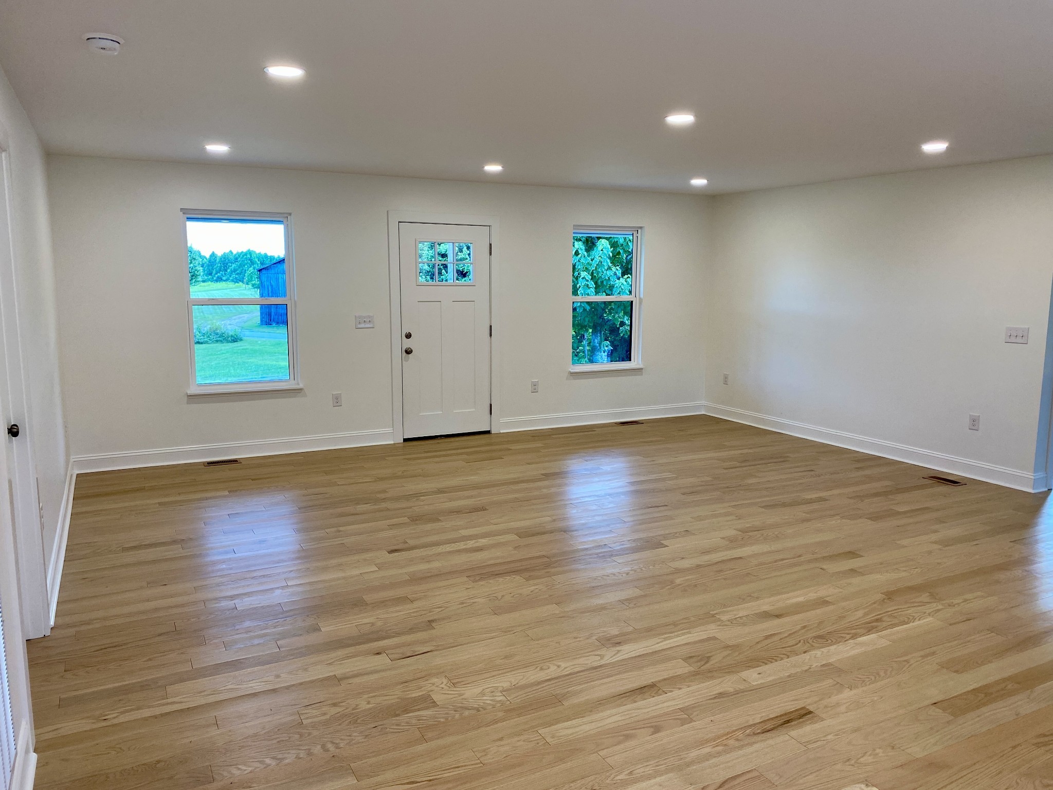 25 Ferguson Hollow Road Chestnut Mound, TN 38552 - Photo 6 of 49 an empty room with wooden floor and windows