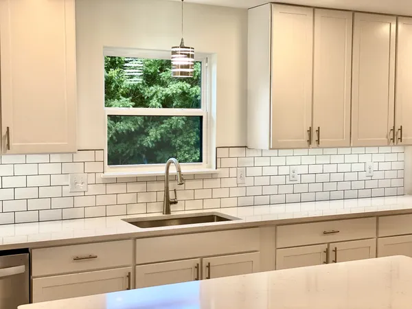 a bathroom with a sink and a window
