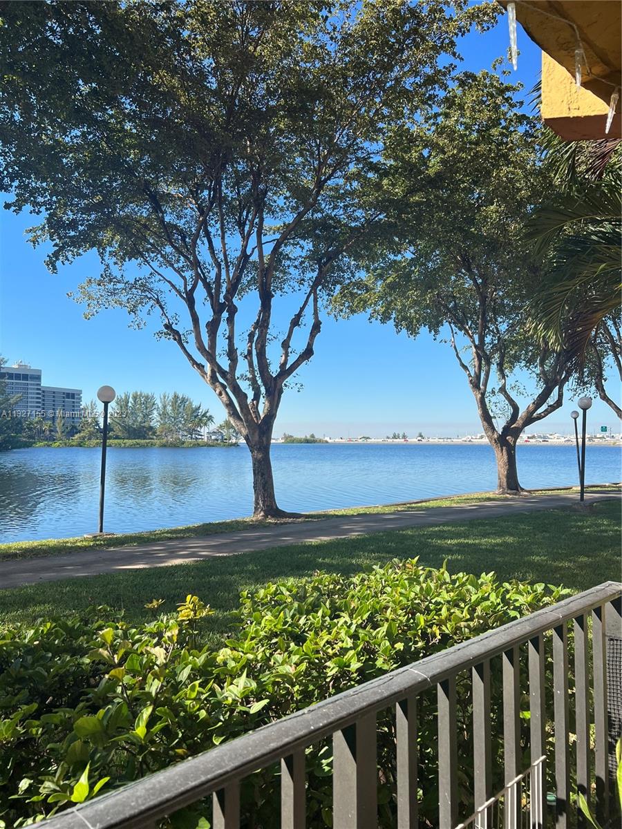 4805 Northwest 7th Street, Unit 10915 Miami, FL 33126 - Photo 1 of 10 a view of a pathway of a yard with wooden fence