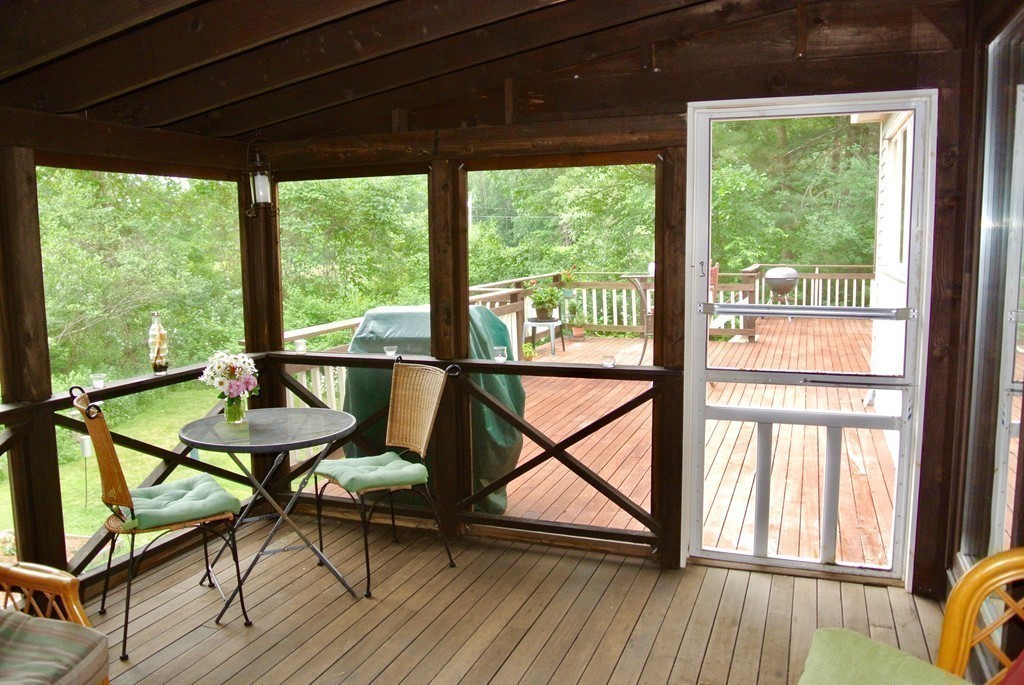 202 Pepperell Road Groton, MA 01450 - Photo 20 of 30 a view of a balcony with chairs and wooden floor