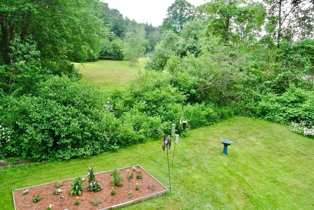 202 Pepperell Road Groton, MA 01450 - Photo 21 of 30 a view of a garden with a bench