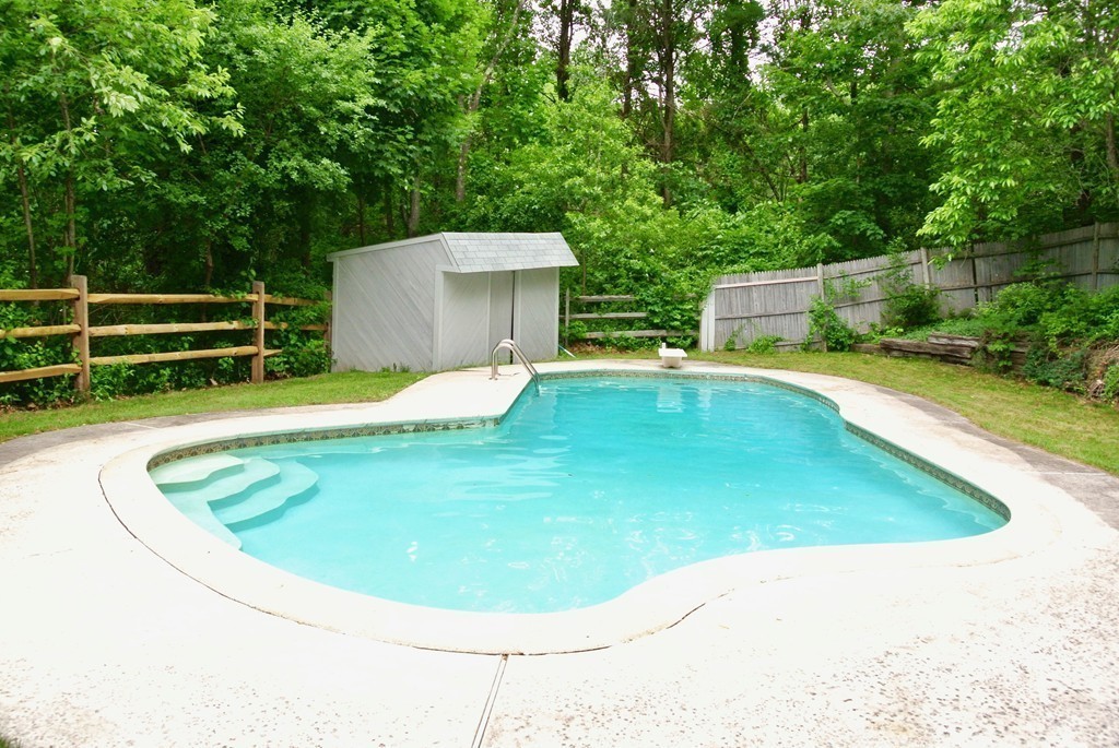 202 Pepperell Road Groton, MA 01450 - Photo 7 of 30 a view of a swimming pool with a yard