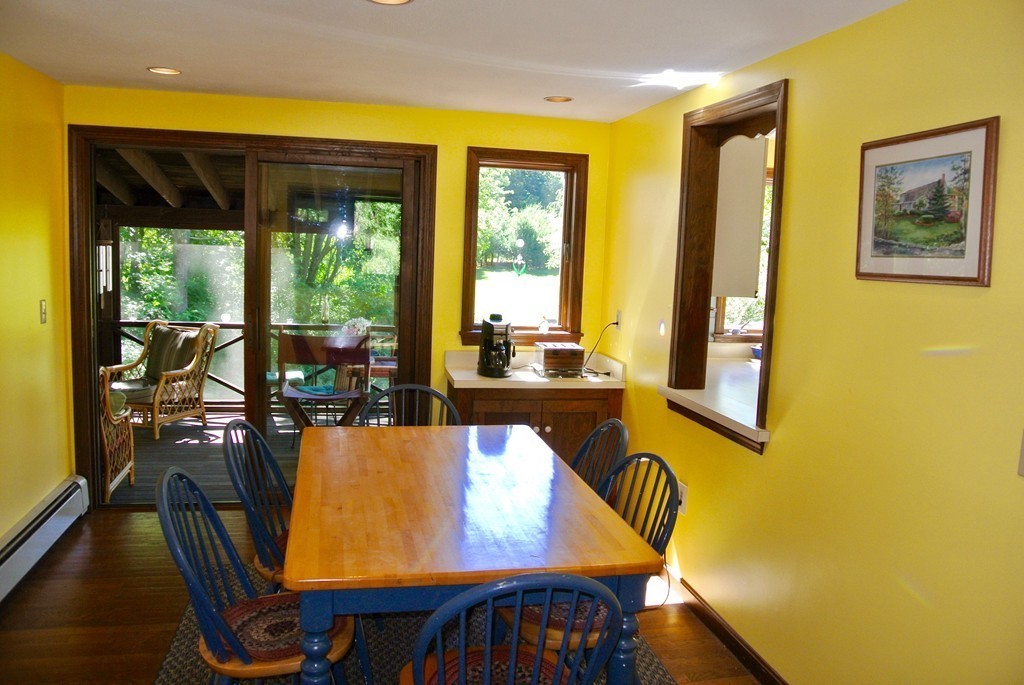 202 Pepperell Road Groton, MA 01450 - Photo 10 of 30 a view of a dining room with furniture and large windows