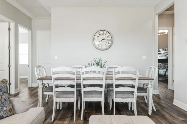 a dining room with furniture and wooden floor