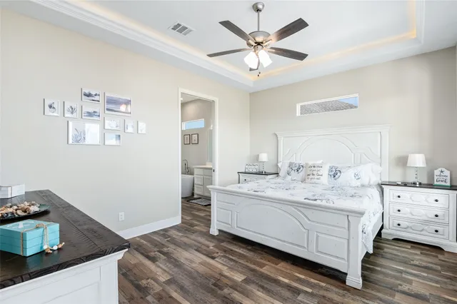 a spacious bedroom with a bed and a chandelier