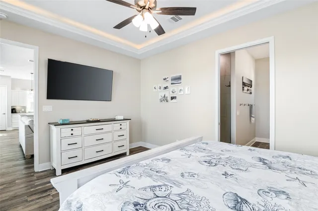 a bedroom with a bed and a flat screen tv in it