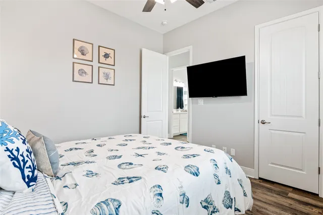 a bedroom with a bed and a flat screen tv