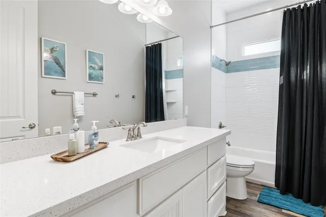 a bathroom with a sink double vanity and a toilet
