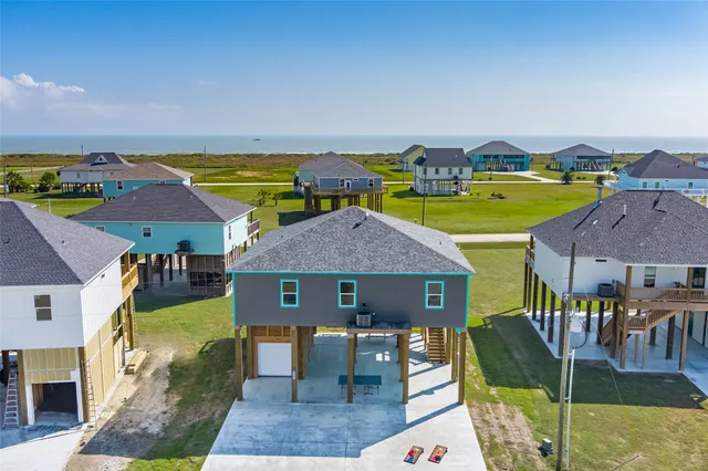 an aerial view of a house with swimming pool outdoor seating