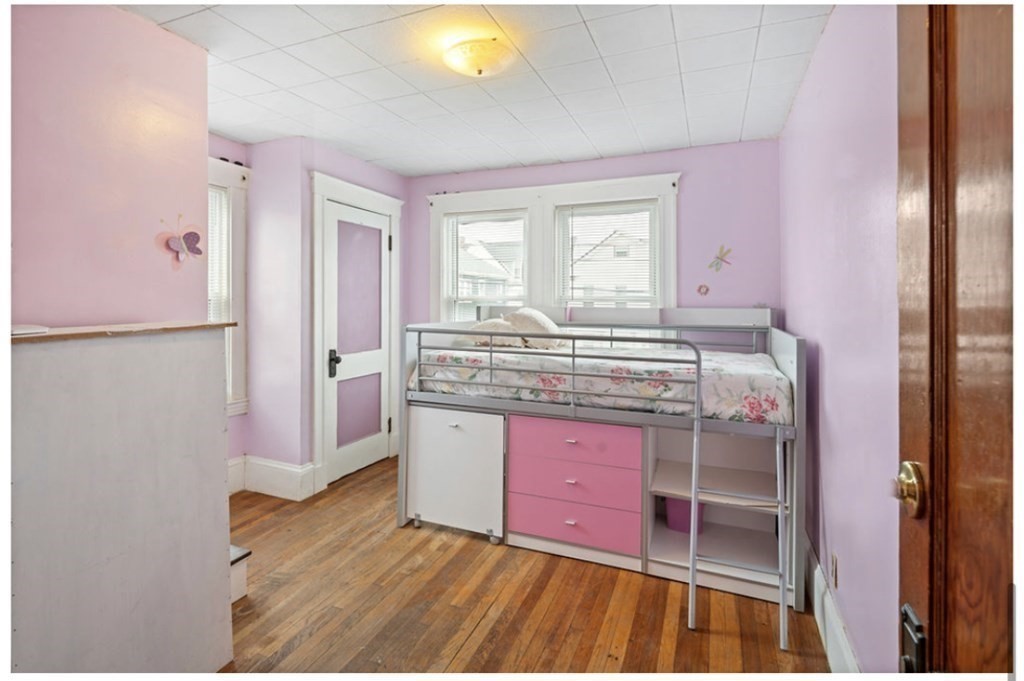 55 Austin Street Boston, MA 02136 - Photo 11 of 24 a room with a bed and a dresser