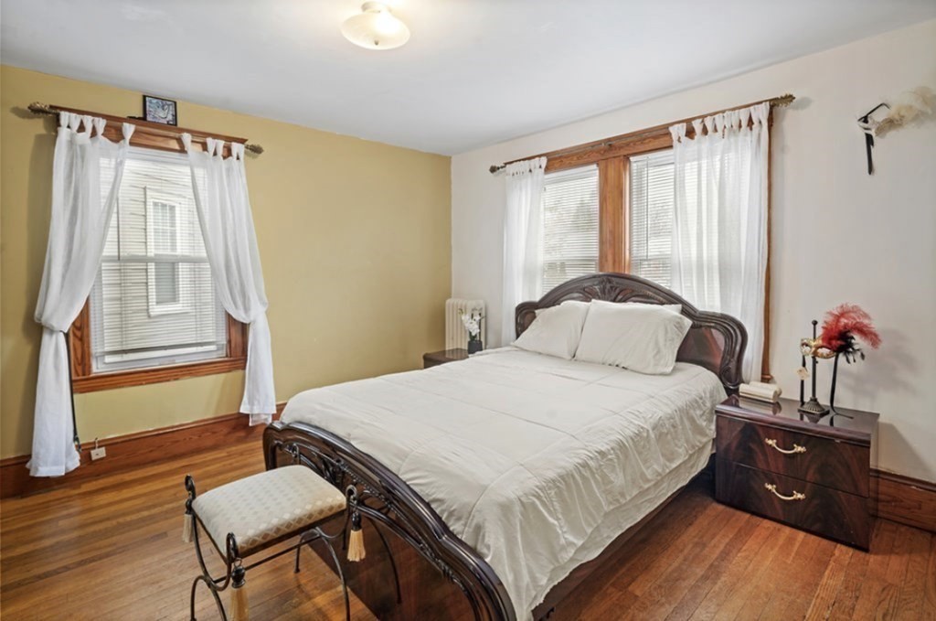 55 Austin Street Boston, MA 02136 - Photo 13 of 24 a bedroom with a bed and wooden floor