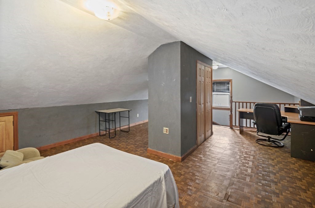 55 Austin Street Boston, MA 02136 - Photo 17 of 24 a bedroom with a bed and wooden floor