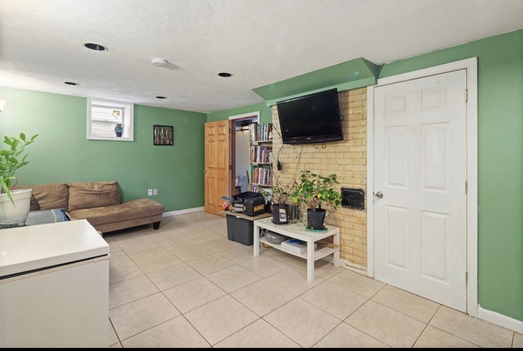55 Austin Street Boston, MA 02136 - Photo 18 of 24 a living room with furniture and a flat screen tv