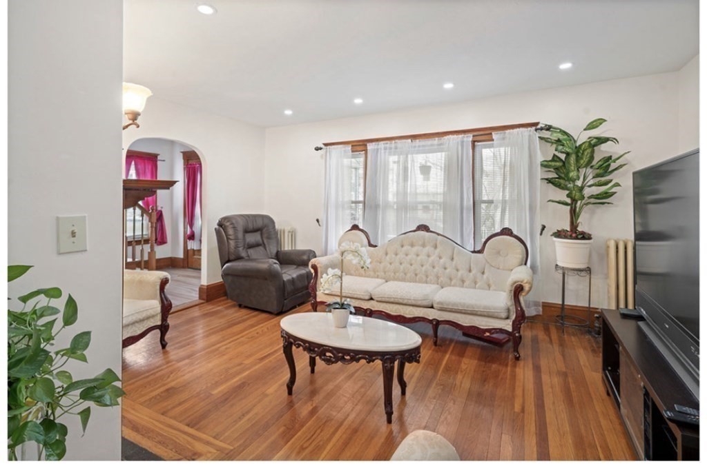 55 Austin Street Boston, MA 02136 - Photo 2 of 24 a living room with furniture and a wooden floor