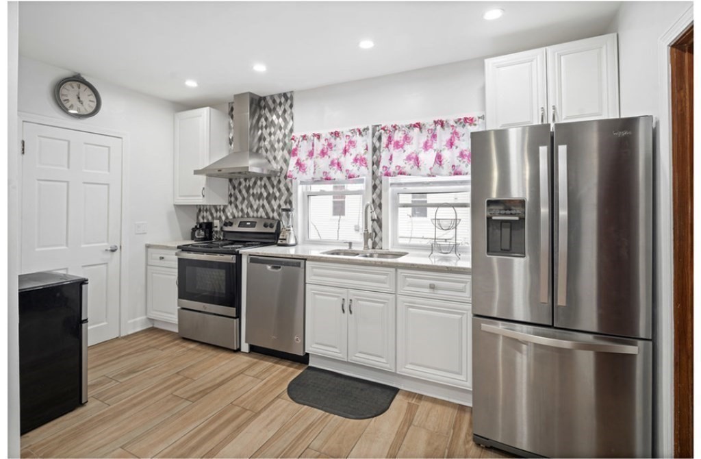 55 Austin Street Boston, MA 02136 - Photo 7 of 24 a kitchen with granite countertop stainless steel appliances a refrigerator and a stove top oven